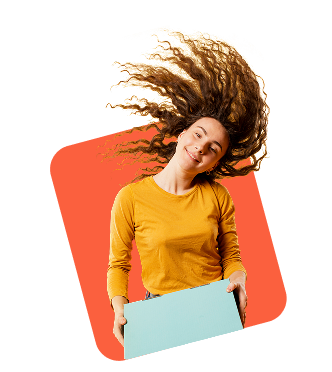 Smiling woman in a yellow top holding a blank board with her hair flying, isolated on an orange background.